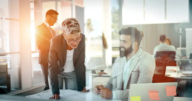 People at a desk discussing FQHC Startup, Expansion, & Operational Planning