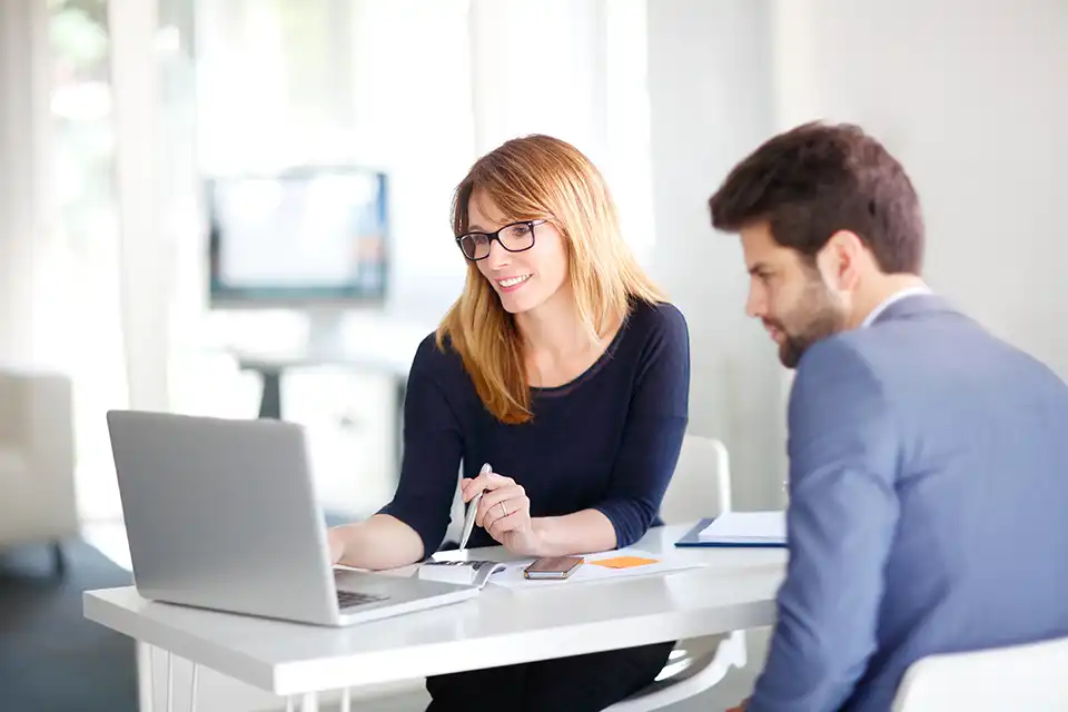 Refine and partner on strategies. A woman giving a presentation.