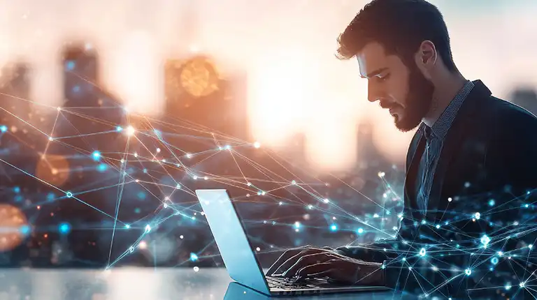 A man working on his computer creating an FQHC technology strategy